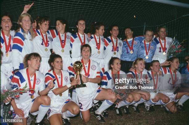Members of the United States squad celebrate with the trophy after the United States team beat Norway 2-1 in the final of the 1991 FIFA Women's World...