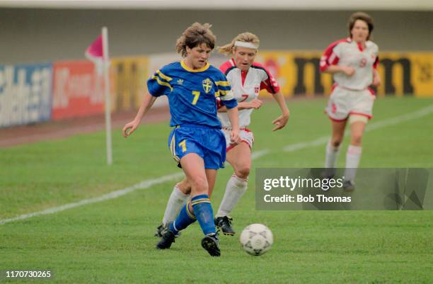 Pia Sundhage of Sweden makes a run with the ball as Tone Haugen of Norway closes in during play in the 1991 FIFA Women's World Cup semi final match...