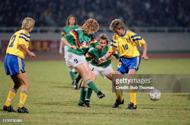 Heidi Mohr of Germany kicks the ball past Lena Videkull of Sweden during play in the 1991 FIFA Women's World Cup third place play off match between...