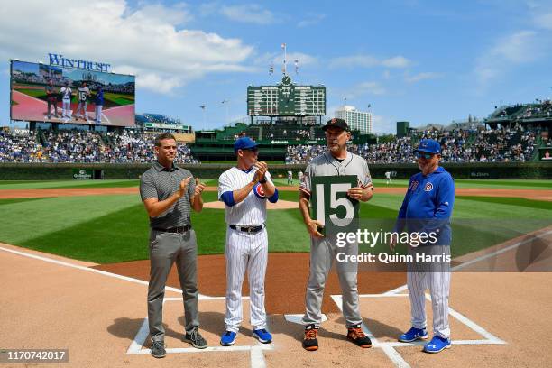 Theo Epstein, Mark Loretta, and Joe Maddon of the Chicago Cubs, pose with Bruce Bochy of the San Francisco Giants before the game to honor is...