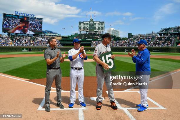 Theo Epstein, Mark Loretta, and Joe Maddon of the Chicago Cubs, pose with Bruce Bochy of the San Francisco Giants before the game to honor is...