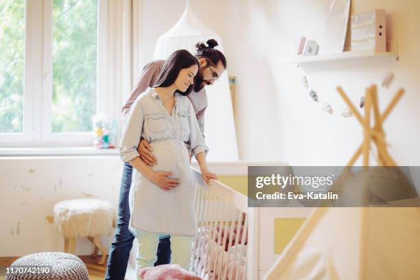 young couple in a shopping store - pregnant couple stock pictures, royalty-free photos & images