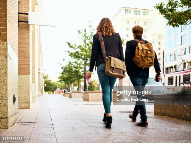 millennials in urban city environment - messenger bag stock pictures, royalty-free photos & images