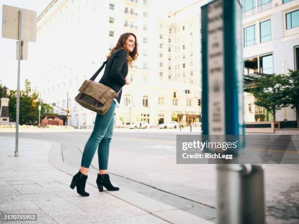 millennial woman in urban city environment - messenger bag stock pictures, royalty-free photos & images