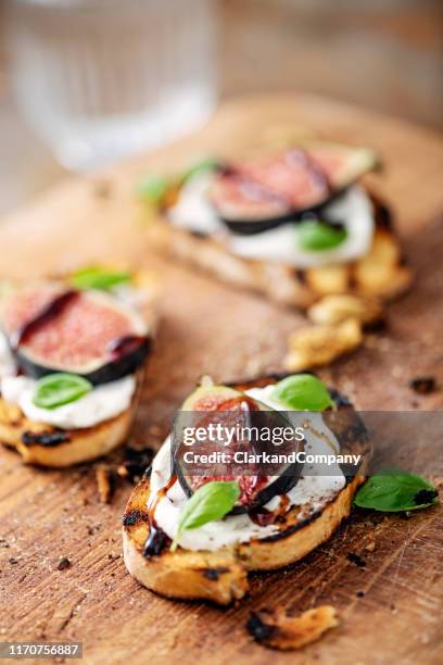 fresh figs with ricotta cheese, balsamic vinegar and fresh basil. - canape stock pictures, royalty-free photos & images