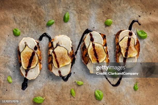 fresh figs with melted goats cheese and balsamic vinegar on toasted bread. - salad dressing stock pictures, royalty-free photos & images