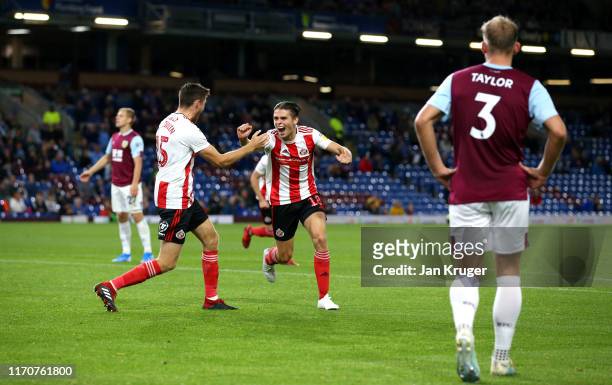 George Dobson of Sunderland AFC celebrates with team mate Jack Baldwin after scoring his team's third goal during the Carabao Cup Second Round match...