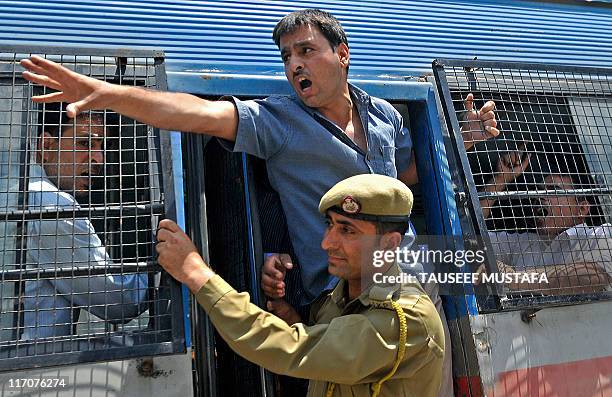 Kashmiri government teacher shouts anti-government slogans as he is arrested by Indian police during a protest in Srinagar on June 14 held to demand...