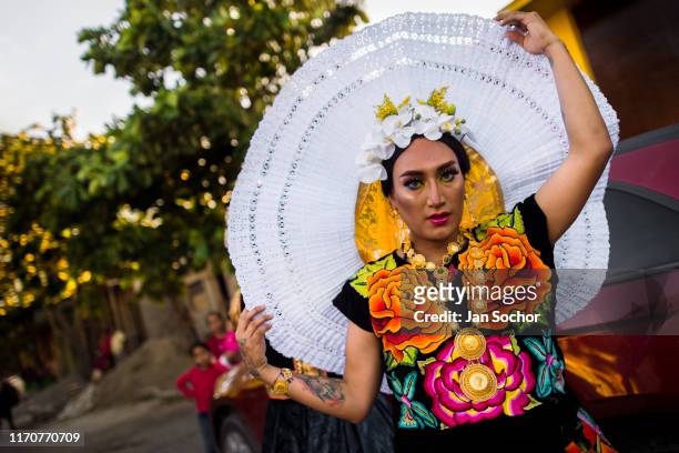 Mexican “muxe” adjusts a Tehuana ceremonial headdress during the Muxes Festival on November 16, 2018 in Juchitán, Mexico. The Zapotec indigenous...