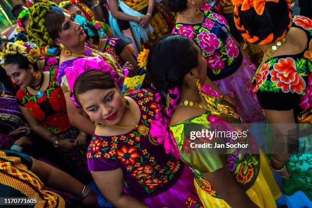 Mexican women of Zapotec origin, wearing traditional Tehuana dress, take part in the traditional procession during the Muxes Festival on November 16,...