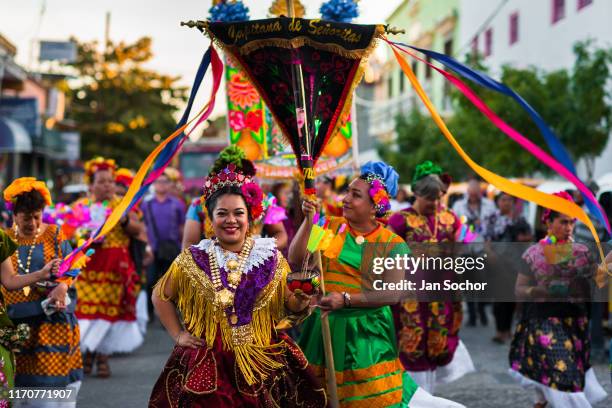 Mexican women of Zapotec origin, wearing traditional Tehuana dress, take part in the traditional procession during the Muxes Festival on November 16,...