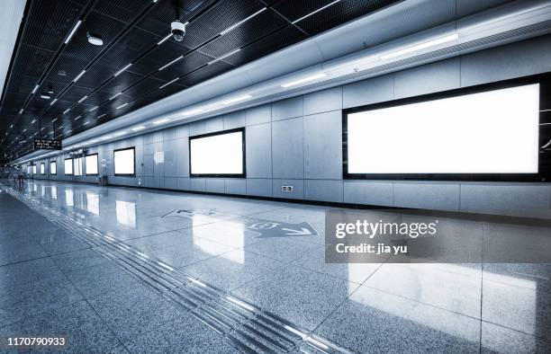 row of blank billboards on wall in subway station - airport terminal interior fotografías e imágenes de stock