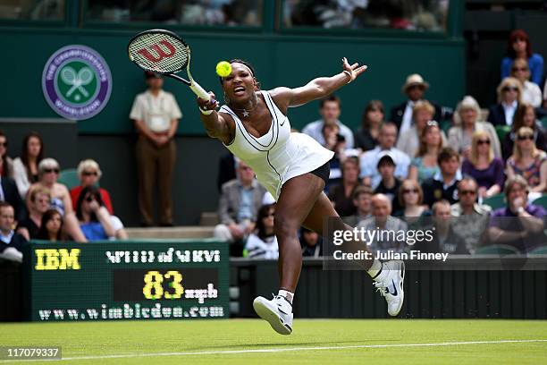 Serena Williams of the United States reaches for a shot during her first round match against Aravane Rezai of France on Day Two of the Wimbledon Lawn...