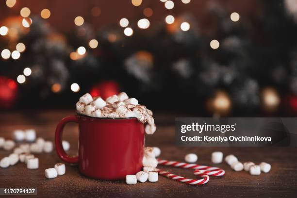 winter whipped cream hot coffee in a red mug with star shaped cookies and warm scarf - rural still life - hot chocolate stock-fotos und bilder