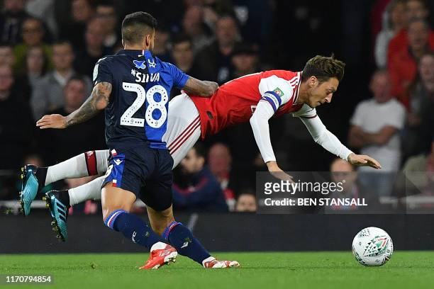 Nottingham Forest's Portuguese midfielder Tiago Silva vies with Arsenal's German midfielder Mesut Ozil during the English League Cup third round...