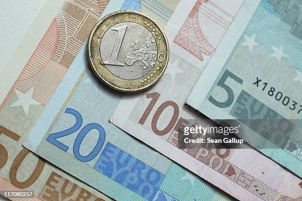 In this photo illustration a one Euro coin lies on Euro currency bills on June 21, 2011 in Berlin, Germany. Eurozone finance ministers are currently...