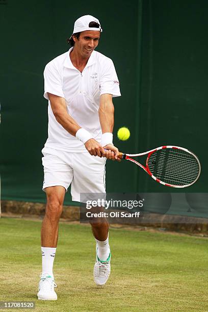 Juan Ignacio Chela of Argentina returns a shot during his first round match against Marinko Matosevic of Australia on Day Two of the Wimbledon Lawn...