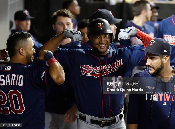 Jonathan Schoop of the Minnesota Twins celebrates in the dugout with teammates after his home run in the eighth inning against the Chicago White Sox...