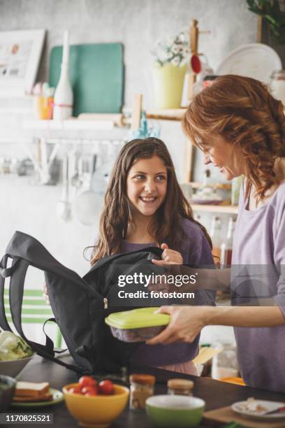 mother and daughter packing school lunch at home - packing food stock pictures, royalty-free photos & images