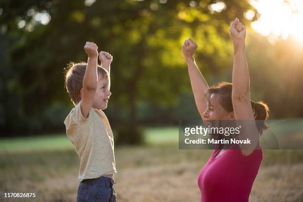 little boy celebrating success with his mother - mom cheering stock pictures, royalty-free photos & images