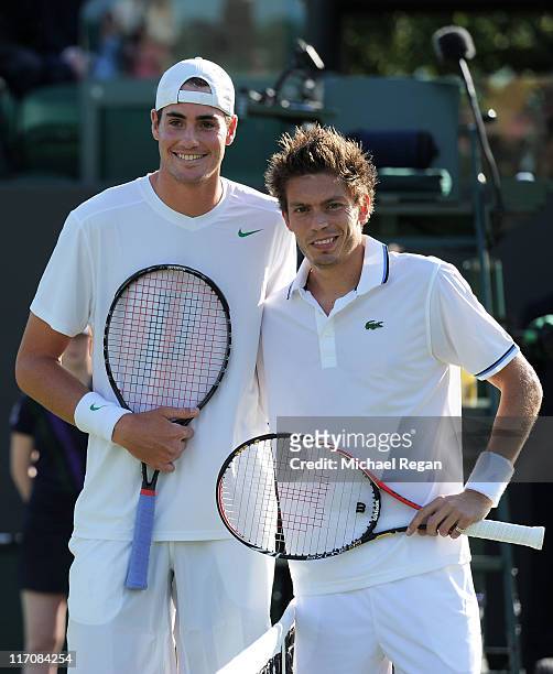 John Isner of the United States and Nicolas Mahut of France pose before their first round match on Day Two of the Wimbledon Lawn Tennis Championships...
