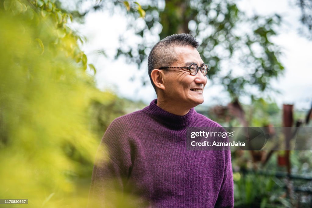 Portrait of Smiling Mature Chinese Man in Outdoor Setting