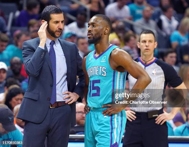 Charlotte Hornets head coach James Borrego, left, talks with guard Kemba Walker during action against the Orlando Magic at Spectrum Center in...