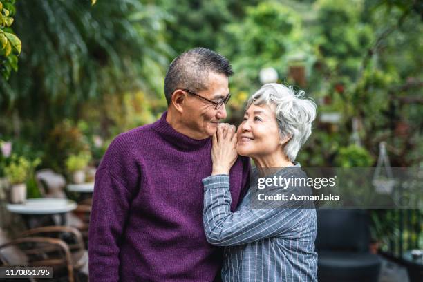 outdoor portrait of devoted senior chinese husband and wife - senior couple smiling stock pictures, royalty-free photos & images