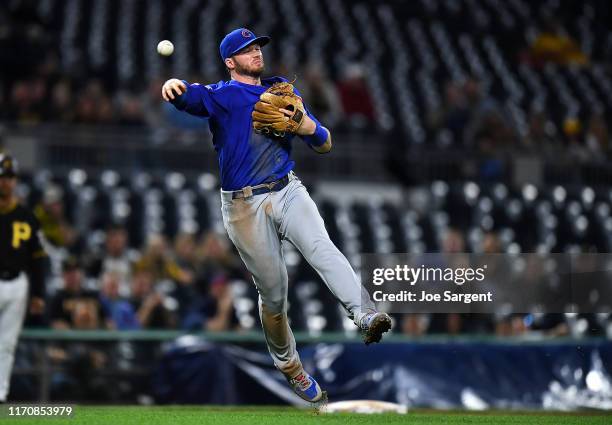 Ian Happ of the Chicago Cubs throws over to first base during the eighth inning against the Pittsburgh Pirates at PNC Park on September 24, 2019 in...