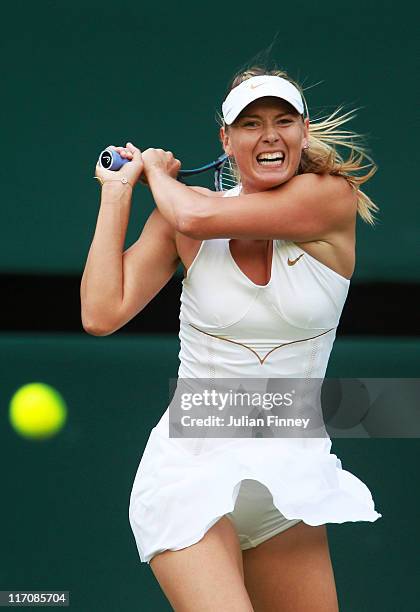 Maria Sharapova of Russia returns a shot during she first round match against Anna Chakvetadze of Russia on Day Two of the Wimbledon Lawn Tennis...