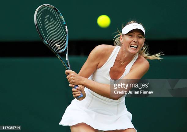 Maria Sharapova of Russia returns a shot during her first round match against Anna Chakvetadze of Russia on Day Two of the Wimbledon Lawn Tennis...