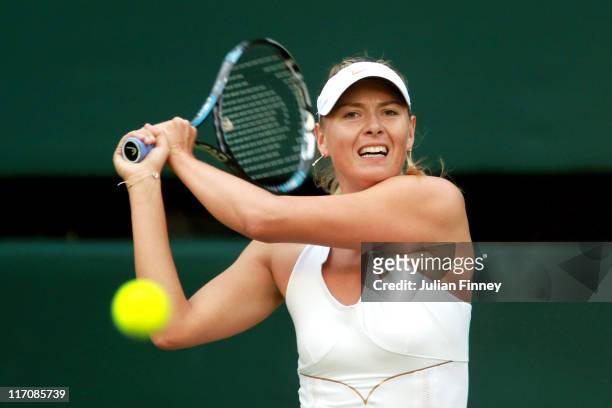 Maria Sharapova of Russia returns a shot during her first round match against Anna Chakvetadze of Russia on Day Two of the Wimbledon Lawn Tennis...