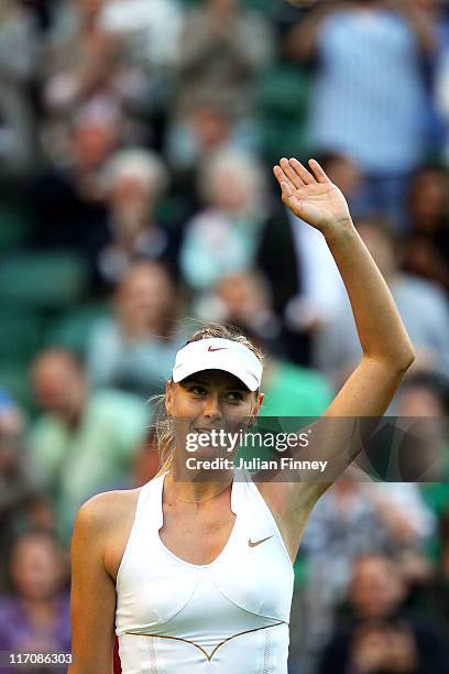 Maria Sharapova of Russia waves to the audience after winning her first round match against Anna Chakvetadze of Russia on Day Two of the Wimbledon...