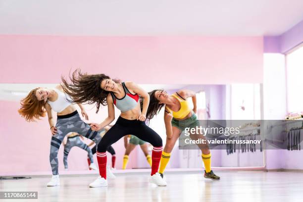professional dancer class dancing in dancing studio - zumba dance stock pictures, royalty-free photos & images