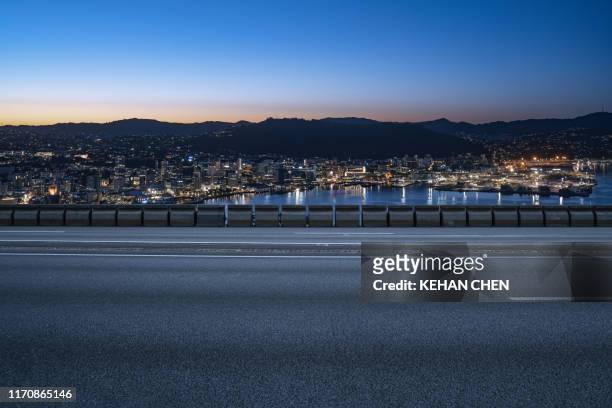empty tarmac road against sunset urban wellington city - speed motion lines to the middle stock pictures, royalty-free photos & images