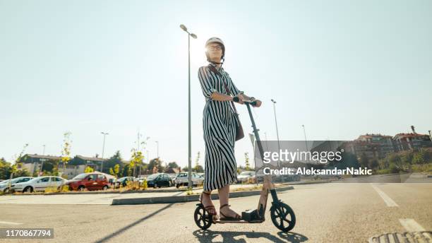 commuting on an electric scooter - push scooter stock pictures, royalty-free photos & images