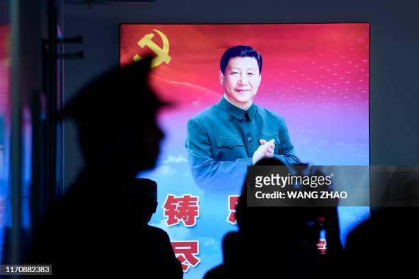 Portrait of China's President Xi Jinping is seen during a tour arranged for the media by the press centre in charge of celebrating the 70th...