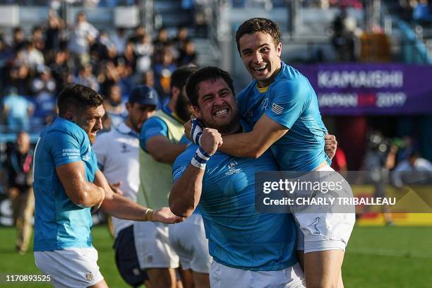 Uruguay's full back Felipe Etcheverry and Uruguay's prop Facundo Gattas celebrate after winning the Japan 2019 Rugby World Cup Pool D match between...