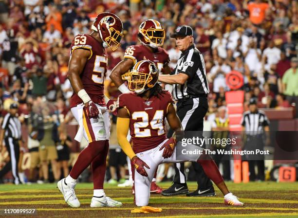 Washington Redskins cornerback Josh Norman looks on after a Redskins penalty, with Washington Redskins inside linebacker Jon Bostic and Washington...