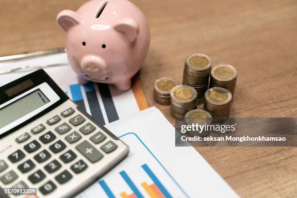 piggy bank and stack of coins - pensioen stockfoto's en -beelden