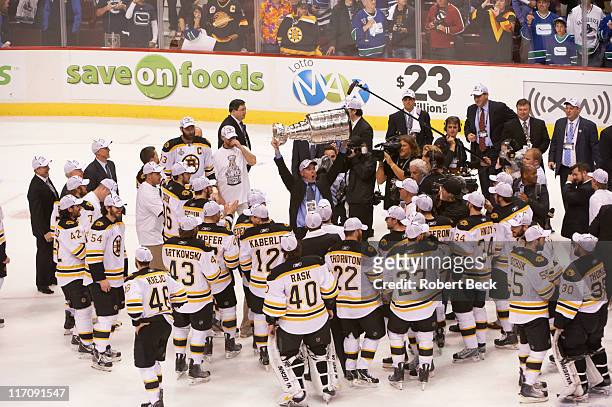 Boston Bruins head coach Claude Julien and team victorious with Stanley Cup trophy after win vs Vancouver Canucks at Rogers Arena. Game 7. Vancouver,...