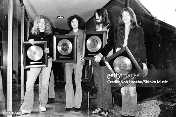 Led Zeppelin, receiving gold discs after a press coference at Tokyo Hilton Hotel, Tokyo, Japan, 30th September 1972. L-R Robert Plant, Jimmy Page,...