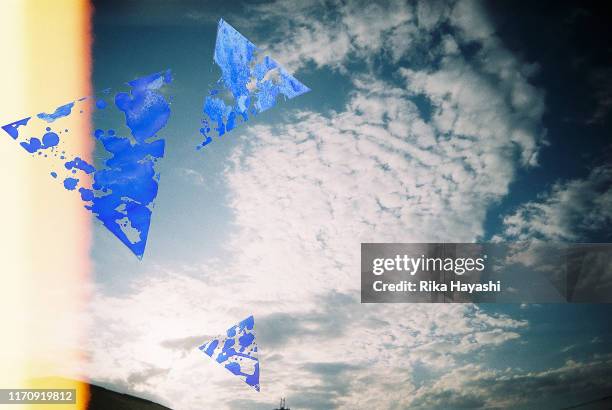 blue sky with clouds, triangle paint shapes in front, and baked film - burnt film stock pictures, royalty-free photos & images