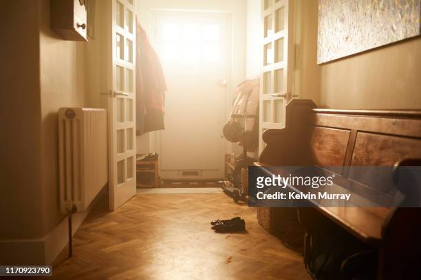 an empty hallway in a family home - family shoes stock-fotos und bilder