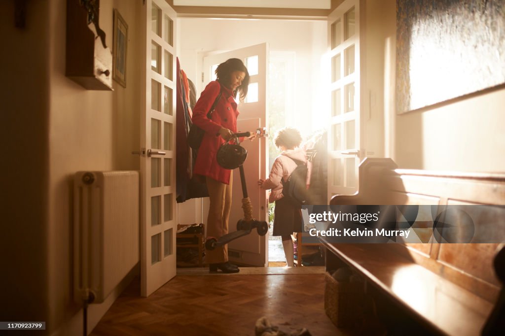 A mother and daughter leaving the house.