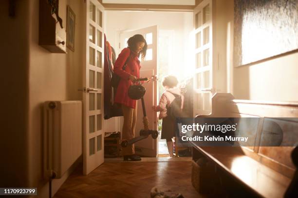 a mother and daughter leaving the house. - work routine imagens e fotografias de stock