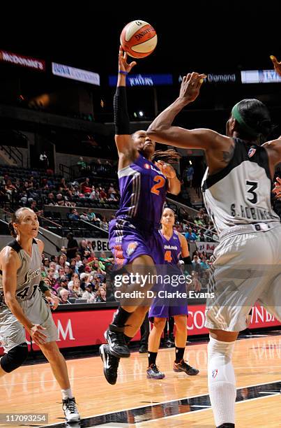 Temeka Johnson of the Phoenix Mercury shoots against Tully Bevilaqua and Scholanda Robinson of the San Antonio Silver Stars at the AT&T Center on...