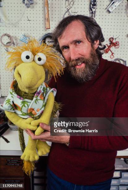American puppeteer, inventor, and filmmaker Jim Henson with one of his creations, Wembley, New York, New York, 1983.