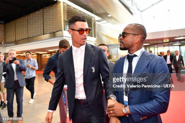 Cristiano Ronaldo speaks to Patrice Evra as they arrive on the red carpet during the UEFA Champions League Draw, part of the UEFA European Club...