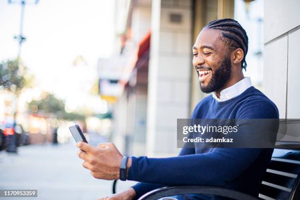 attractive young businessman sitting - african cornrow braids stock pictures, royalty-free photos & images